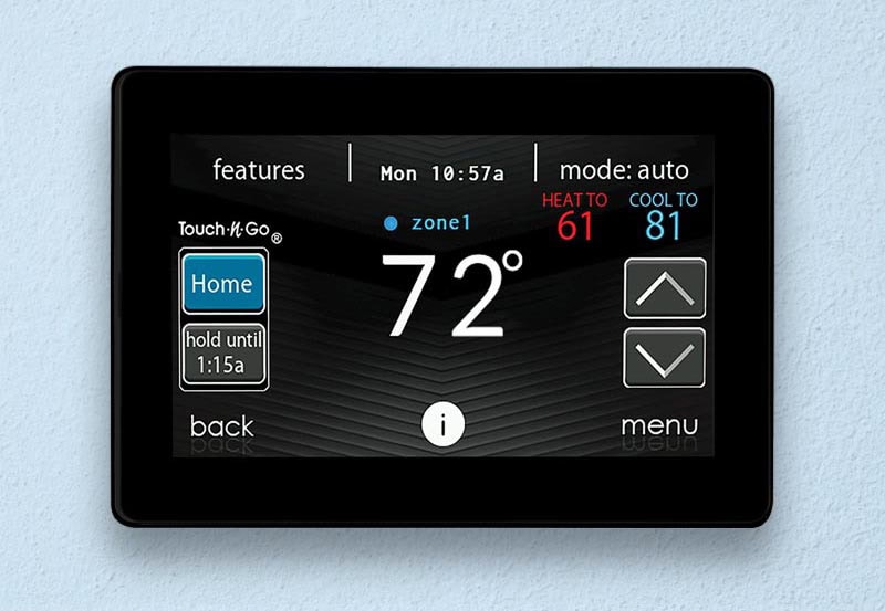 Digital screen of a black smart thermostat highlighting the indoor temperature is at 72 degrees.