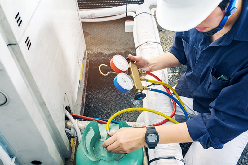 HVAC maintenance being performed on a heat pump.
