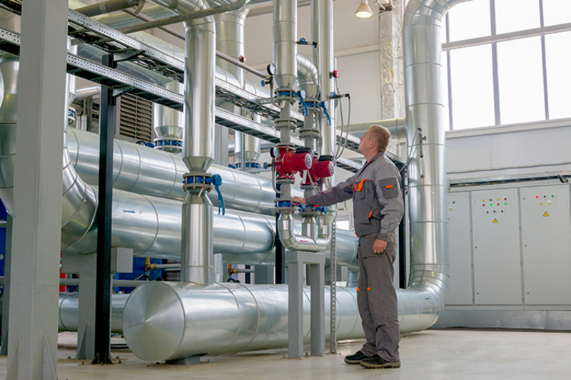 technician performing maintenance on a commercial HVAC system.