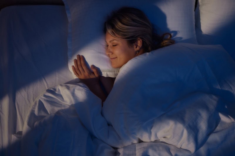 Woman sleeping in bed.